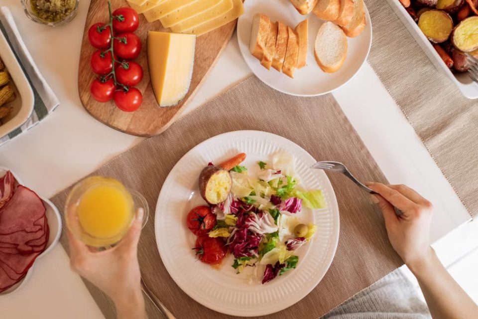 Top view of a delicious homemade meal with cheese, salad, and assorted ingredients.